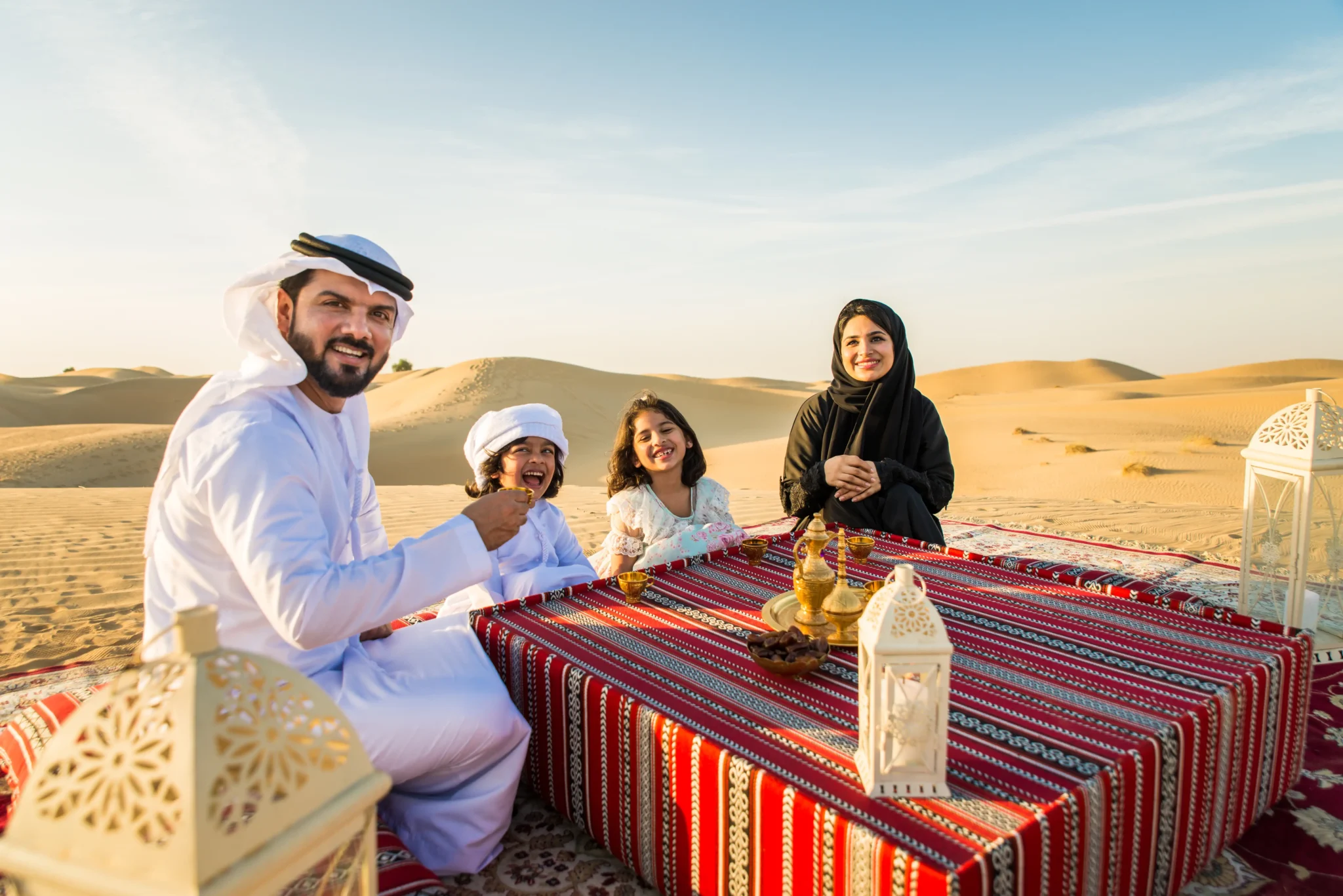 Tourists enjoying desert safari tours in Al Ain with comfortable luxury bus and minivan transport for group and private trips across UAE